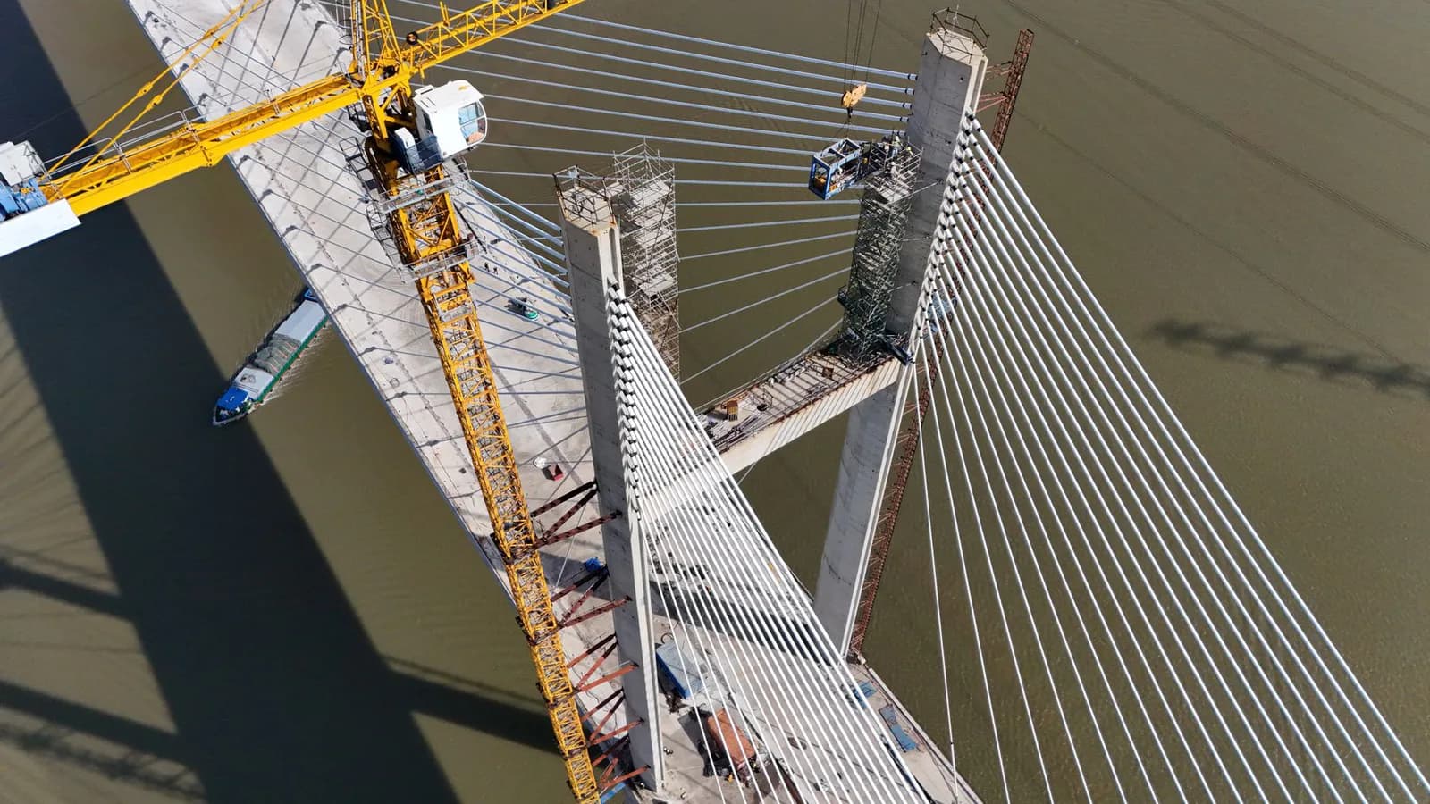 Aerial view of cable-stayed bridge construction over a river